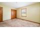 The carpeted bedroom has a window, a closet, and neutral colored walls at 1376 Garland Ln, Lincolnton, NC 28092