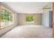 Spacious carpeted bedroom bathed in natural light from large windows and modern ceiling fan at 1376 Garland Ln, Lincolnton, NC 28092