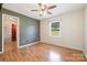 The bedroom has laminate floors, a window, and an adjacent bathroom at 1376 Garland Ln, Lincolnton, NC 28092