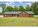 Charming single-story brick home featuring a well-manicured lawn and classic black shutters at 1376 Garland Ln, Lincolnton, NC 28092