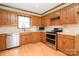 Traditional kitchen with wood cabinets, tiled backsplash, modern stainless steel appliances, and lots of natural light at 1376 Garland Ln, Lincolnton, NC 28092