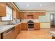 Traditional kitchen featuring wood cabinetry, stainless steel appliances, and tiled countertops at 1376 Garland Ln, Lincolnton, NC 28092