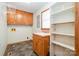 Laundry room with tile flooring, utility sink, storage cabinets and shelves at 1376 Garland Ln, Lincolnton, NC 28092