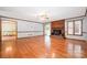 Expansive living room featuring gleaming hardwood floors, a brick fireplace, and natural light through wide windows at 1376 Garland Ln, Lincolnton, NC 28092