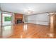 Light-filled living room showcasing hardwood floors, a brick fireplace, and glass paneled door providing access to a covered patio at 1376 Garland Ln, Lincolnton, NC 28092