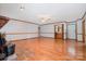 Spacious living room featuring hardwood floors, classic trim, a ceiling fan and a cozy brick fireplace at 1376 Garland Ln, Lincolnton, NC 28092