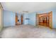 The carpeted living room connects to additional rooms, with a ceiling fan and ample natural light at 1376 Garland Ln, Lincolnton, NC 28092