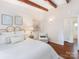Bright bedroom featuring decorative wood beams, hardwood floors, and a decorative wall at 1438 Larkfield Ln, Charlotte, NC 28210