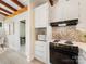This kitchen features a built-in microwave, tiled backsplash, and white cabinets at 1438 Larkfield Ln, Charlotte, NC 28210