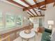 Spacious living room with exposed beams, hardwood floors, and a view of the dining area at 1438 Larkfield Ln, Charlotte, NC 28210