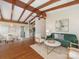 Open-concept living space with exposed beams, hardwood floors, and stylish decor at 1438 Larkfield Ln, Charlotte, NC 28210