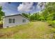 The backyard view reveals a well-kept lawn surrounded by lush trees and a classic fence at 1495 Memorial Park Rd # 10, Lancaster, SC 29720