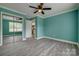 Well-lit bedroom featuring gray wood flooring, an open closet, and views of the kitchen at 1495 Memorial Park Rd # 10, Lancaster, SC 29720