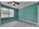 Stylish bedroom with gray wood floors, ceiling fan, and natural light from the large window at 1495 Memorial Park Rd # 10, Lancaster, SC 29720