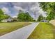 Driveway leading to a home, set against a backdrop of green trees and a cloudy sky at 1495 Memorial Park Rd # 10, Lancaster, SC 29720