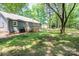Grassy backyard with trees and a wooden deck, perfect for outdoor entertaining at 1522 Stafford Ext, Monroe, NC 28110