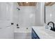 Bright white bathroom featuring a bathtub, white tiled wall, and wood paneled ceiling at 1522 Stafford Ext, Monroe, NC 28110