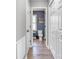 Hallway view of a bathroom with patterned wallpaper and neutral flooring at 1522 Stafford Ext, Monroe, NC 28110