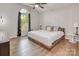 Bright bedroom with a large bed, wood floors, vaulted ceiling, and a large window at 1522 Stafford Ext, Monroe, NC 28110
