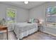 Cozy bedroom featuring wood floors, two windows, and neutral-colored walls at 1522 Stafford Ext, Monroe, NC 28110