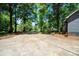 Long driveway leading to a well-maintained home surrounded by lush trees and greenery at 1522 Stafford Ext, Monroe, NC 28110