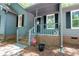 Inviting front porch with brick accents, black shutters and well manicured front yard at 1522 Stafford Ext, Monroe, NC 28110