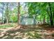 Detached two car garage surrounded by lush greenery and trees at 1522 Stafford Ext, Monroe, NC 28110
