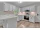 Bright kitchen with white cabinets, stainless steel appliances, and marble countertops at 1522 Stafford Ext, Monroe, NC 28110