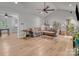 Spacious living room with wood-look floors, a ceiling fan, and plenty of natural light at 1522 Stafford Ext, Monroe, NC 28110