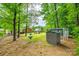 Expansive backyard featuring lush greenery, a storage shed, and an inviting outdoor living space at 1623 Mulberry Cir, Rock Hill, SC 29730