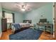 Comfortable bedroom boasts wood floors, soft blue accents, and natural light at 1623 Mulberry Cir, Rock Hill, SC 29730