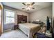 Simple carpeted bedroom with large window and ceiling fan at 1623 Mulberry Cir, Rock Hill, SC 29730