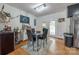 Bright dining area with a glass table, modern chandelier, and convenient access to the deck at 1623 Mulberry Cir, Rock Hill, SC 29730