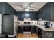 Well-equipped kitchen with black cabinets, stainless steel fridge, and updated fixtures at 1623 Mulberry Cir, Rock Hill, SC 29730