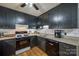 Functional kitchen featuring black cabinets, tiled backsplash, and modern appliances at 1623 Mulberry Cir, Rock Hill, SC 29730