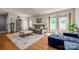 Bright living room features hardwood floors, a plush sofa, ottoman, and abundant natural light at 1623 Mulberry Cir, Rock Hill, SC 29730