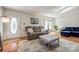 Cozy living room with hardwood floors, plush sofa, ottoman, area rug, and natural light at 1623 Mulberry Cir, Rock Hill, SC 29730