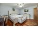 Charming bedroom features hardwood floors, large bed, and neutral decor at 1623 Mulberry Cir, Rock Hill, SC 29730