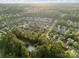 An aerial view of a lush neighborhood with a community pool surrounded by mature trees and green landscape at 1688 Avalon Dr, Rock Hill, SC 29730