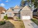 Beautiful home with stone and siding exterior, attached garage, and a lush front lawn in a desirable neighborhood at 1688 Avalon Dr, Rock Hill, SC 29730