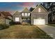 Charming two-story home featuring a stone and siding exterior, complemented by a well-manicured lawn at 1688 Avalon Dr, Rock Hill, SC 29730
