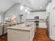 Bright kitchen features a large island with a sink, granite countertops, stainless steel appliances, and hardwood floors at 1688 Avalon Dr, Rock Hill, SC 29730