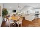 Open-concept living space with a modern kitchen island, dining area, and a cozy fireplace in the background at 1688 Avalon Dr, Rock Hill, SC 29730