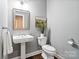 Well-lit powder room with a pedestal sink, modern fixtures, and tasteful decor for guests' convenience at 1688 Avalon Dr, Rock Hill, SC 29730