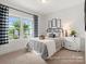 Cozy bedroom with a metal frame bed, black and white accents, and a bright window overlooking a lawn at 181 Montgomery Pl # 726, Mount Gilead, NC 27306