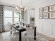 Formal dining room featuring a dark wood table, elegant chandelier, and stylish decor at 181 Montgomery Pl # 726, Mount Gilead, NC 27306
