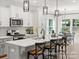 Bright kitchen with white cabinets, a large kitchen island, modern stainless-steel appliances, and contemporary pendant lighting at 181 Montgomery Pl # 726, Mount Gilead, NC 27306