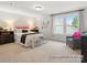 Airy primary bedroom with a queen-sized bed, bench, accent chair, and a window offering a scenic view at 181 Montgomery Pl # 726, Mount Gilead, NC 27306