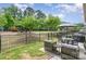 Relaxing outdoor patio area with seating, BBQ, and views of a well-maintained green space at 1849 Fleetwood Dr, Charlotte, NC 28208