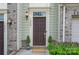 Charming front door with manicured bushes and a 'hello' welcome mat at 1849 Fleetwood Dr, Charlotte, NC 28208